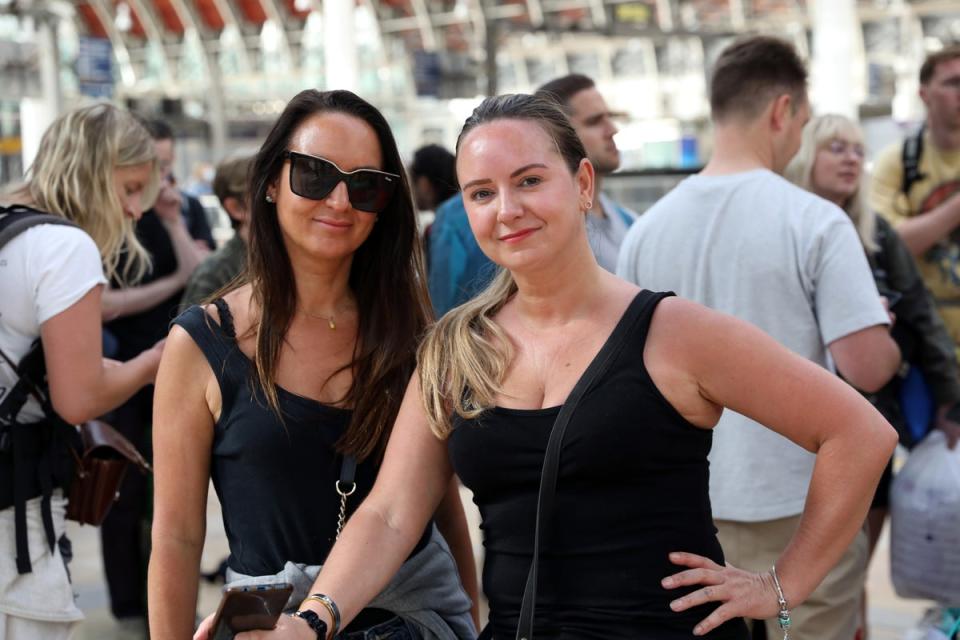 Rebecca and Victoria Wilkinson arrived early to board their train to Glastonbury Festival (Ashlee Ruggels/PA) (PA Wire)