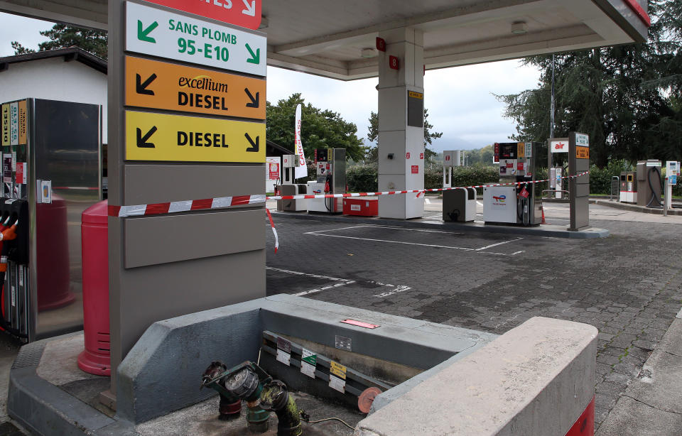 A red and white ribbon prevents the entrance at a closed gas station in Saint Jean de Luz, southwestern France, Wednesday, Oct.12, 2022. The French government on Wednesday started the process of requisitioning workers at petrol depots of ExxonMobil's French branch Esso in an attempt to ensure that service stations around the country are supplied with badly needed fuel amid an ongoing strike, saying shortages are becoming "unbearable" to too many in the country. (AP Photo/Bob Edme)