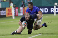 Scotland's Stuart Hogg is tackled by Samoa's Ed Fidow during the Rugby World Cup Pool A game at Kobe Misaki Stadium between Scotland and Samoa in Kobe City, Japan, Monday, Sept. 30, 2019. (AP Photo/Aaron Favila)