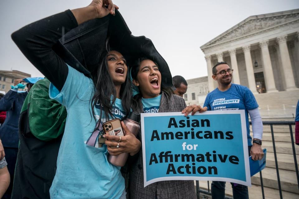 FILE - Harvard students Shruthi Kumar, left, and Muskaan Arshad, join a rally with other activists as the Supreme Court hears oral arguments on a pair of cases that could decide the future of affirmative action in college admissions, in Washington, Monday, Oct. 31, 2022. A new poll from The Associated Press-NORC Center for Public Affairs Research found that 63% of Americans say the Supreme Court should not stop colleges from considering race or ethnicity in their admission systems. (AP Photo/J. Scott Applewhite, File)