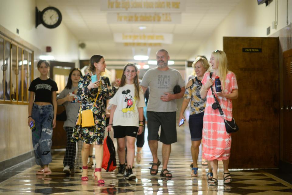 Soon-to-be students of Topeka High School and their families are given a tour of the school by Pilar Mejia, director of cultural innovation for the district, prior to their first day Thursday afternoon.