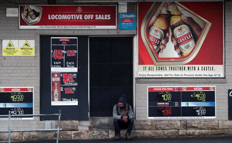 A bystander sits outside a closed liquor store during a nationwide lockdown due to the outbreak of the coronavirus disease (COVID-19), in Cape Town