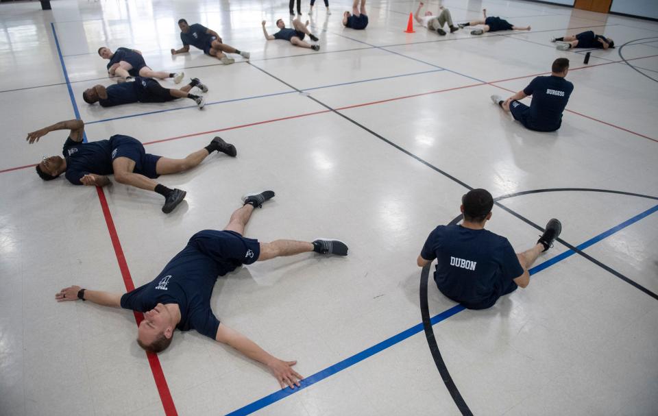 Recruits with the Southwestern Indiana Law Enforcement Academy stretch following a physical training class at CK Newsome Community Center in Evansville, Ind., Tuesday afternoon, April 12, 2022. 