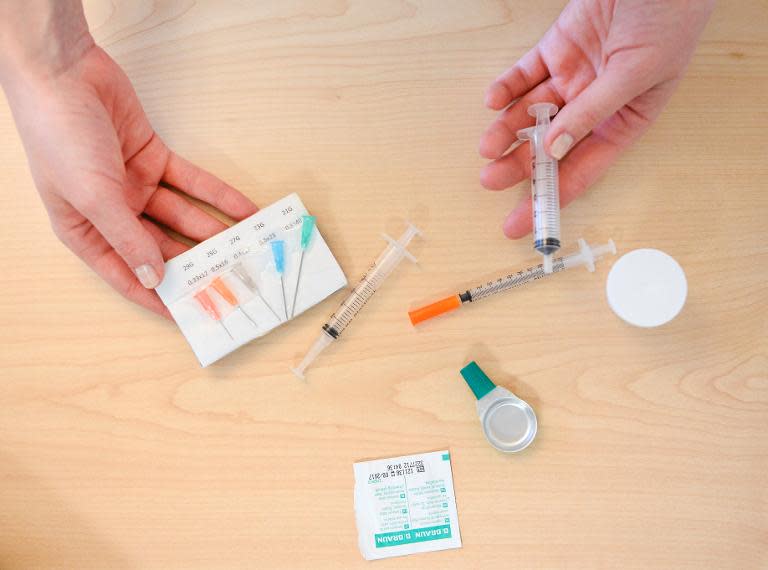 A nurse prepares a kit for drug addicts at a needle exchange facility located at St Goeran's hospital in Stockholm, on April 2, 2014