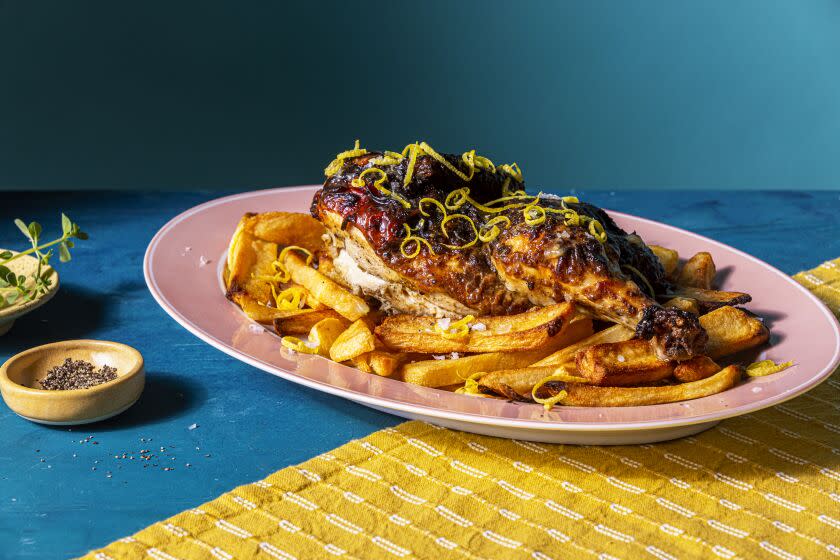 EL SEGUNDO, CALIFORNIA, June 30, 2022: Lemon and Oregano Half-Chicken served over thick-cut fries - a recipe from Ben Mims photographed for his column on Thursday, June 30, 2022, at the Los Angeles Times' test kitchen in El Segundo, Cali. (Silvia Razgova / For the Times, Prop Styling / Jennifer Sacks) Assignment ID: 976065