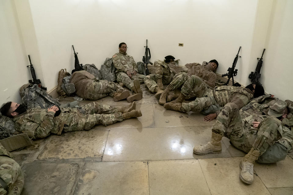 WASHINGTON, DC - JANUARY 13: Members of the National Guard rest in the U.S. Capitol on January 13, 2021 in Washington, DC. Security has been increased throughout Washington following the breach of the U.S. Capitol last Wednesday, and leading up to the Presidential inauguration. (Photo by Stefani Reynolds/Getty Images)