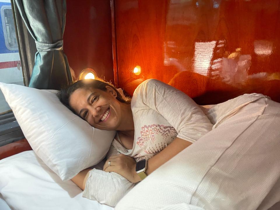 Woman laying in bed in train cabin.