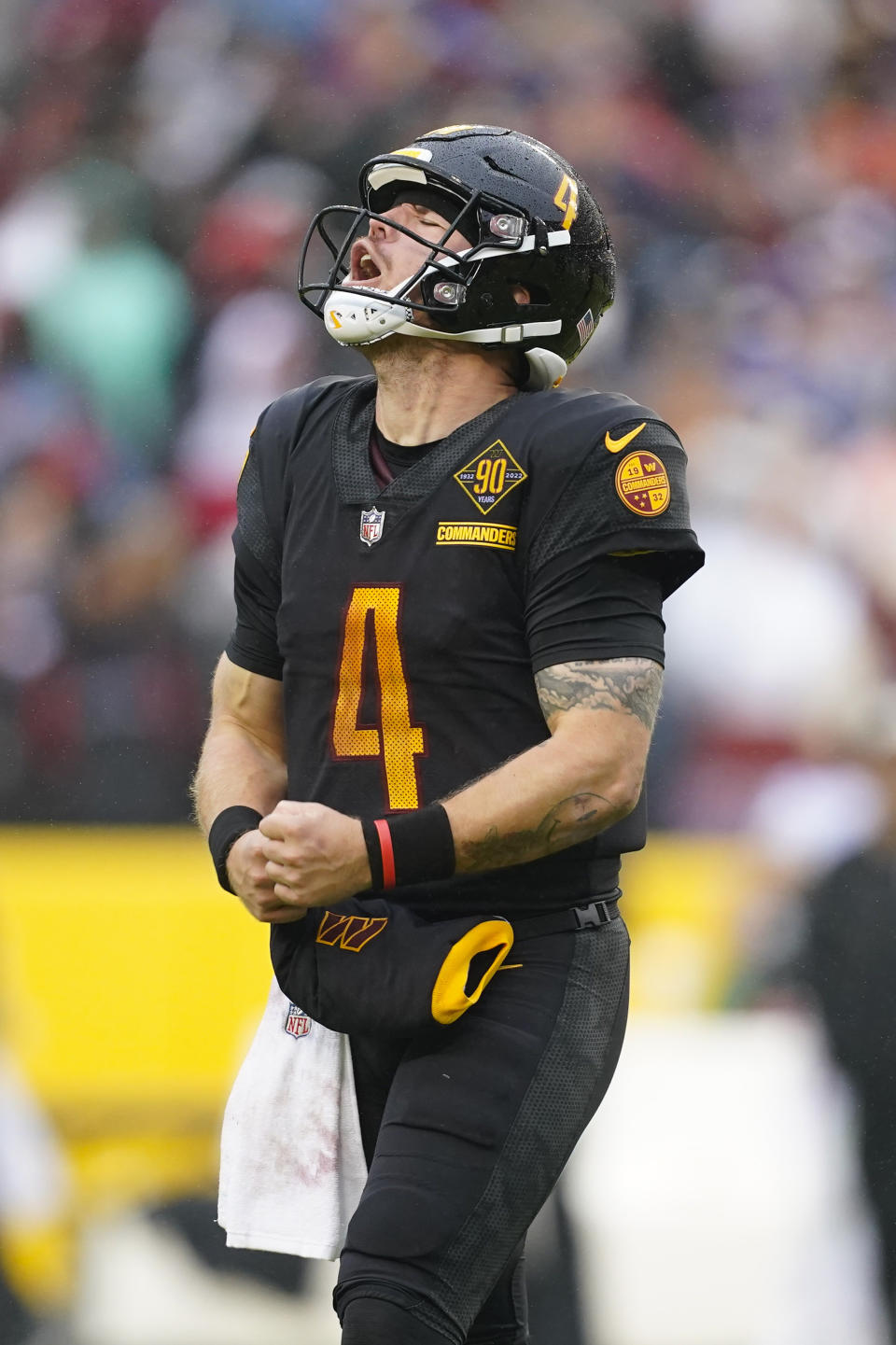 Washington Commanders quarterback Taylor Heinicke (4) reacting after throwing a touchdown pass to tight end John Bates during the second half of an NFL football game against the Atlanta Falcons, Sunday, Nov. 27, 2022, in Landover, Md. (AP Photo/Patrick Semansky)