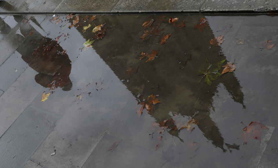Britain's Parliament buildings are reflected in a muddy puddle in London, Monday, Oct. 21, 2019. The European Commission says the fact that British Prime Minister Boris Johnson did not sign a letter requesting a three-month extension of the Brexit deadline has no impact on whether it is valid and that the European Union is considering the request. (AP Photo/Kirsty Wigglesworth)