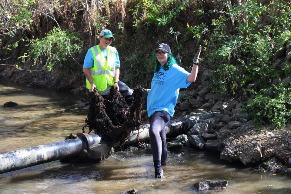 Glennis Desensi and Ashley Desensi clean up the Columbus tributary, Weracoba Creek, during “Sweep the Hooch” in 2022.