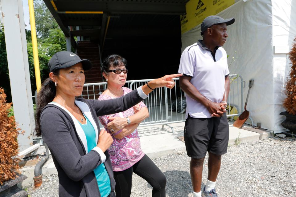 Kylene Murray with her parents Ligaya and Kela Simunyola at the shell of the center's building at the Mount Vernon tennis center on Aug. 6, 2018.