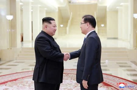 North Korean leader Kim Jong Un shakes hands with a member of the special delegation of South Korea's President in this photo released by North Korea's Korean Central News Agency (KCNA) on March 6, 2018. KCNA/via Reuters