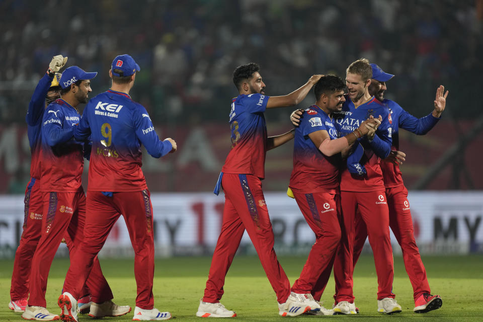 Royal Challengers Bengaluru's Karn Sharma, third right, is congratulated by teammates for taking the wicket of Punjab Kings' Rilee Rossouw during the Indian Premier League cricket match between Punjab Kings and Royal Challengers Bengaluru in Dharamshala, India, Thursday, May 9, 2024. (AP Photo /Ashwini Bhatia)