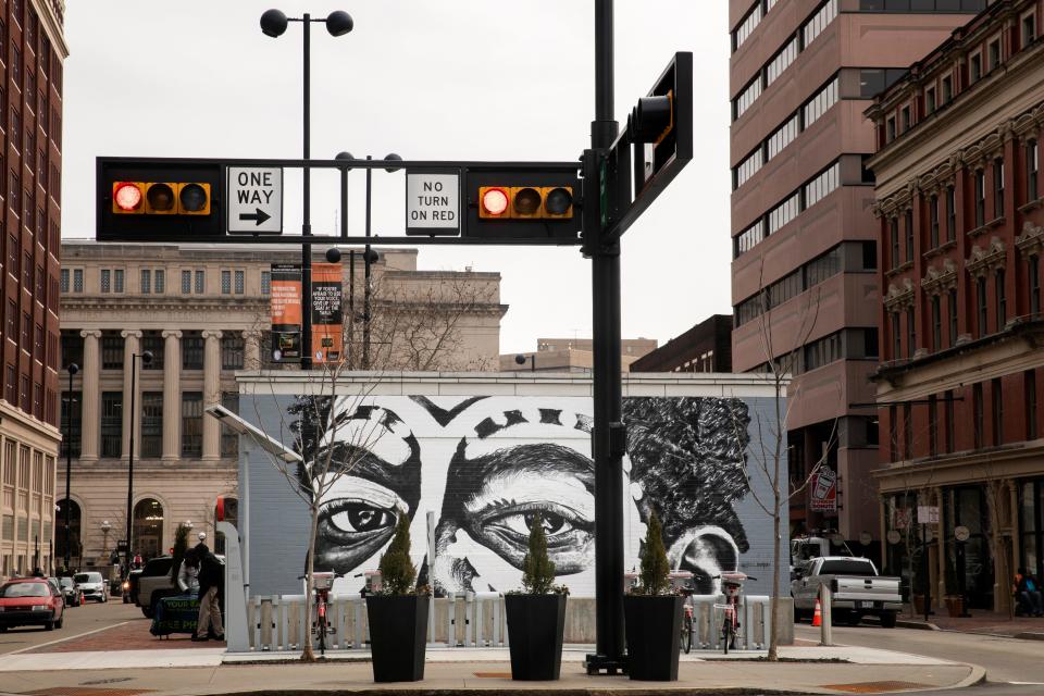 "Coming of Age" mural by visual artist Gee Horton is on display on the Court Street Plaza in downtown Cincinnati. Purchase his work, and that of other local Black artists, this weekend at Findlay Market as part of Black Art on Black Friday.