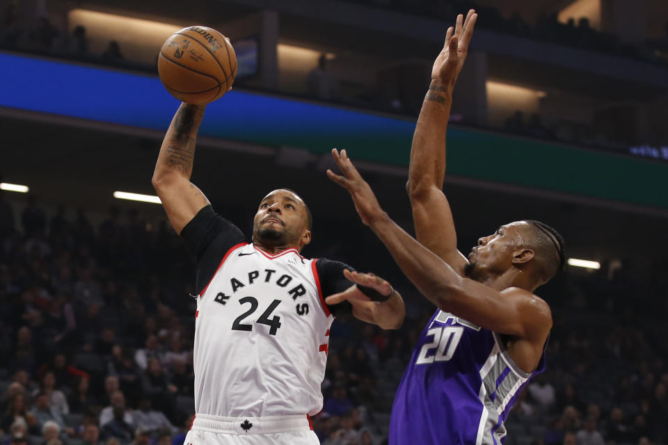 Toronto Raptors guard Norman Powell, left, goes to the basket against Sacramento Kings forward Harry Giles III, right, during the first quarter of an NBA basketball game in Sacramento, Calif., Sunday, March 8, 2020. (AP Photo/Rich Pedroncelli)