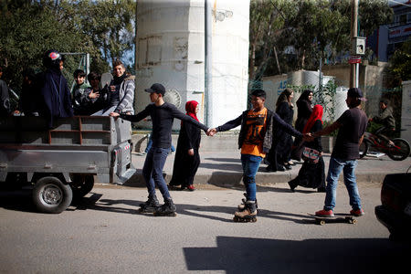 Members of Gaza Skating Team, Mohammad Al-Sawalhe, 23, and Mustafa Sarhan, 19, practice their rollerblading and skating skills on a street in Gaza City March 10, 2019. REUTERS/Mohammed Salem