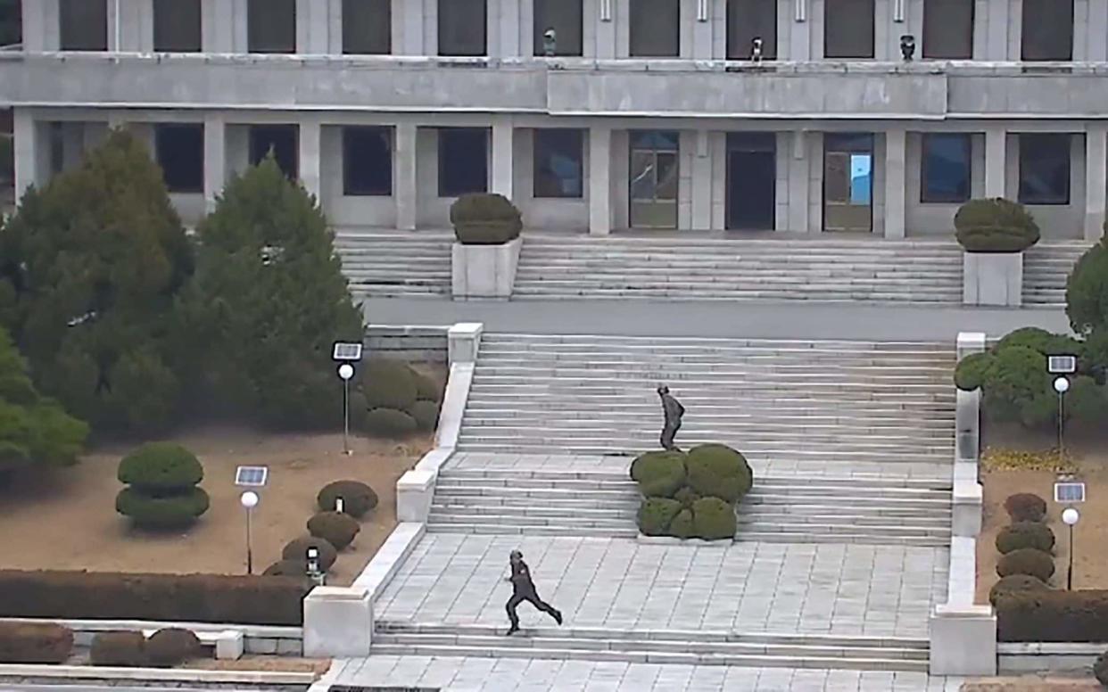  North Korea soldiers reacting to the news of a defection from Panmungok - AFP