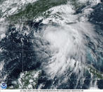 This satellite photo provided by the National Oceanic and Atmospheric Administration shows Tropical Storm Sally, Sunday, Sept. 13, 2020, at 2050 GMT. Sally churned northward on Sunday, poised to turn into a hurricane and send a life-threatening storm surge along the northern Gulf of Mexico. (NOAA via AP)