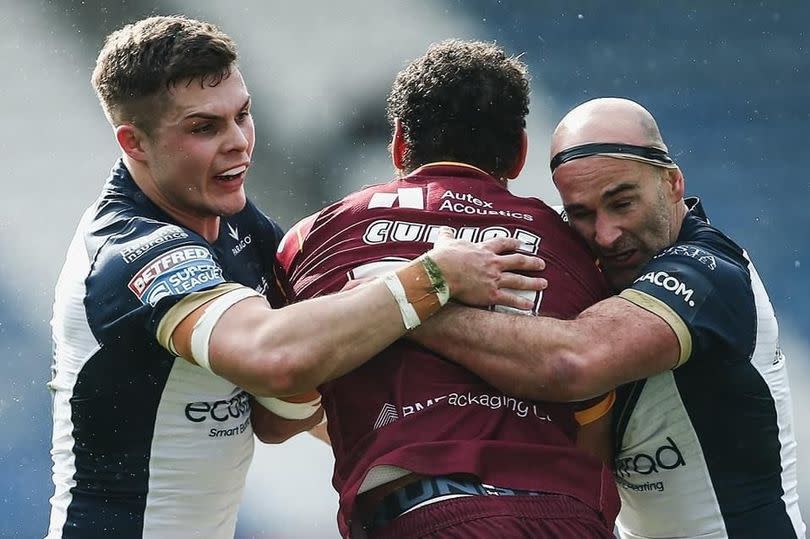 Hull FC's Cam Scott and Danny Houghton make a tackle.