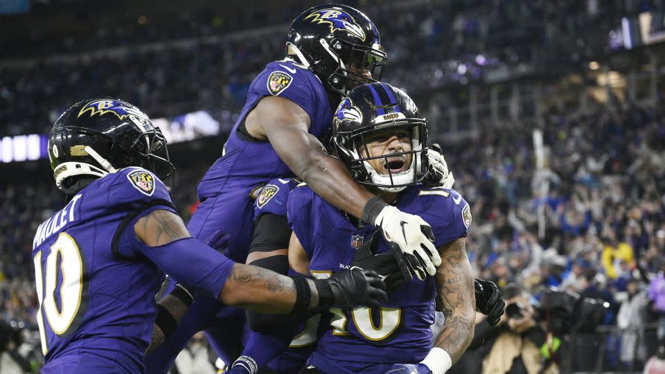 Wallace celebrates with teammates after his game-winning punt return against the Rams. - Nick Wass/AP