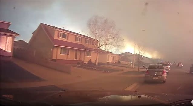 The fire is seen burning across the road from homes. Photo: YouTube