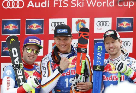 Alpine Skiing - FIS Alpine Skiing World Cup - Men's Alpine Downhill - Kitzbuehel, Austria - January 20, 2018 - Beat Feuz of Switzerland, Thomas Dressen of Germany and Hannes Reichelt of Austria react in the leader box. REUTERS/Leonhard Foeger