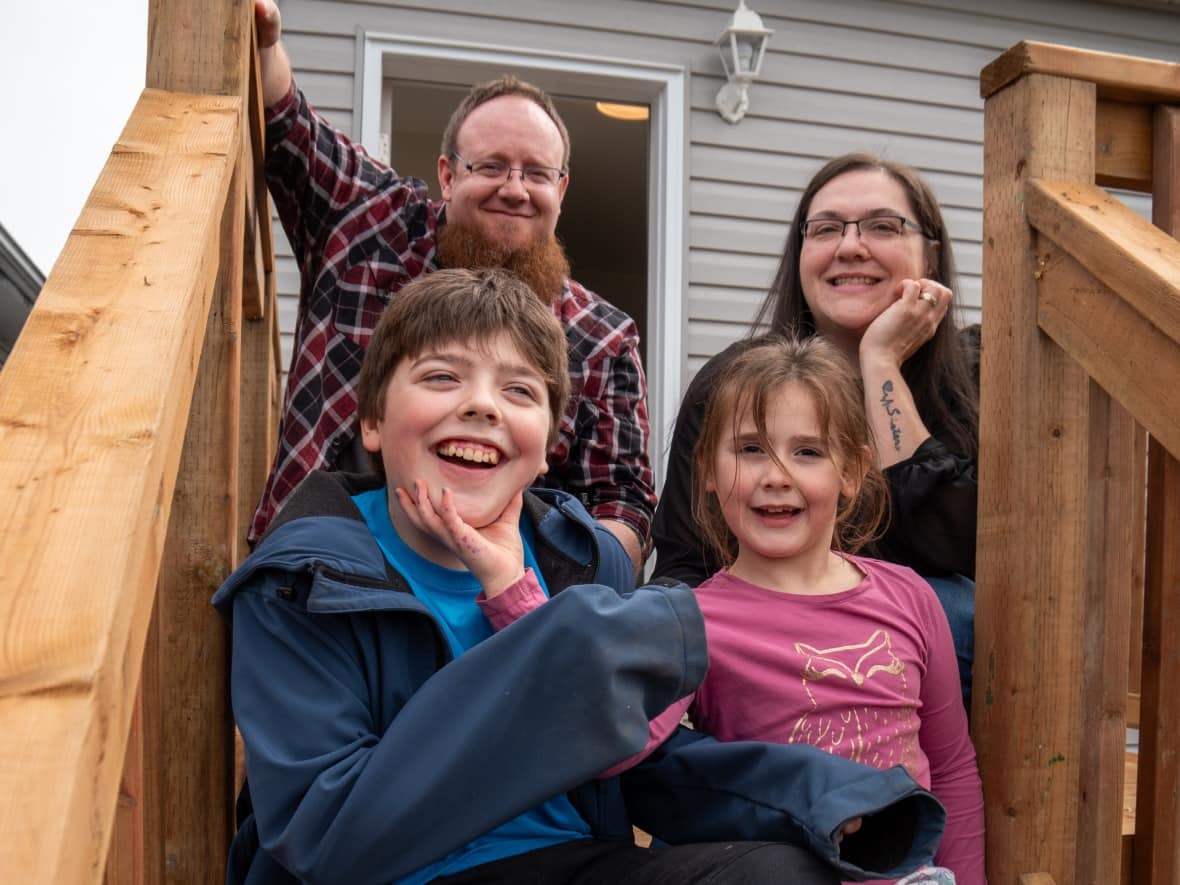 The Slater family celebrates getting the keys to their new Habitat for Humanity Thunder Bay home in northwestern Ontario. Parents Tyrell and Krystale Slater say they're excited for their children, Kole and Payge, to have a backyard for the first time. (Sarah Law/CBC - image credit)