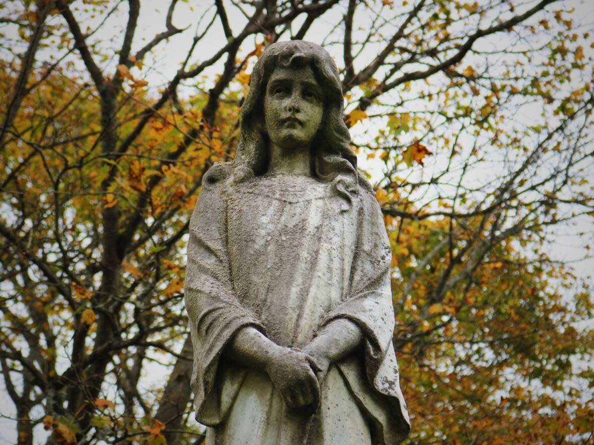 The haunting gaze of a statue in east Saint John's Fernhill Cemetery dedicated to nine-year-old Violet Barton, who died in 1911. (Julia Wright/CBC - image credit)