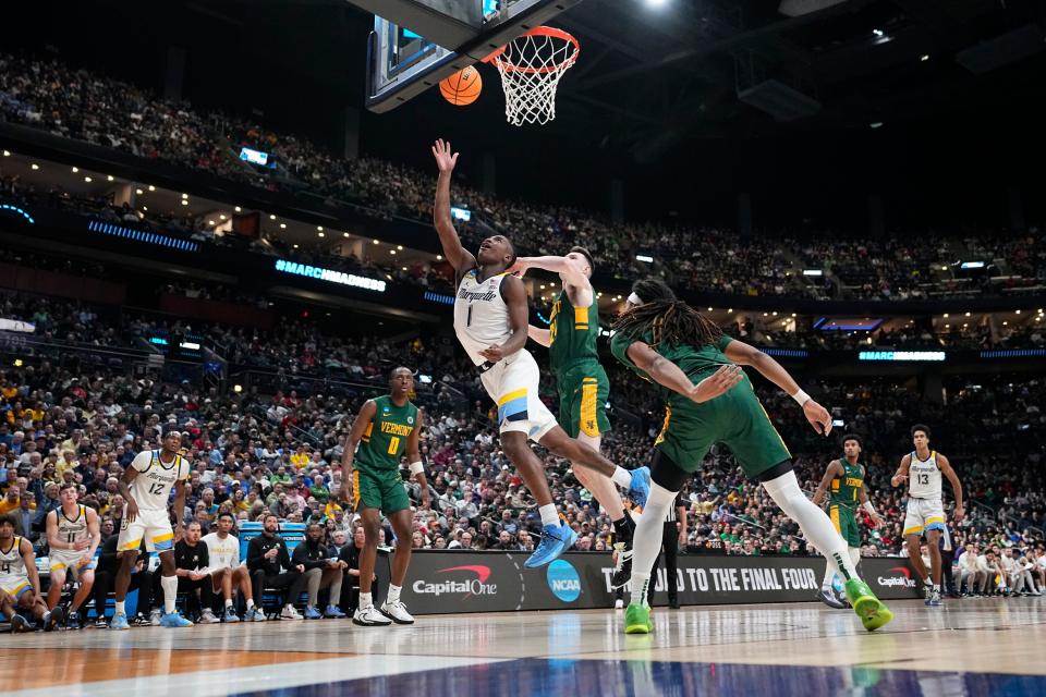 Mar 17, 2023; Columbus, Ohio, USA;  Marquette Golden Eagles guard Kam Jones (1) drives to the basket past Vermont Catamounts forward Matt Veretto (24) during the first round of the NCAA men’s basketball tournament at Nationwide Arena. Marquette won 78-61. Mandatory Credit: Adam Cairns-The Columbus Dispatch