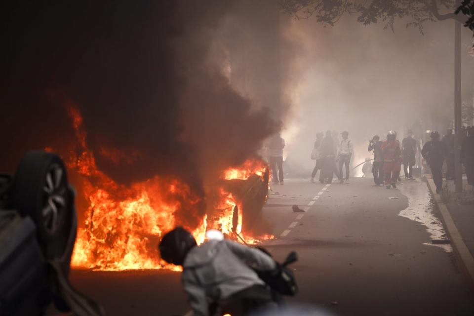 A fire burns in the middle of a street during clashes between protesters and French riot police on Thursday (EPA)