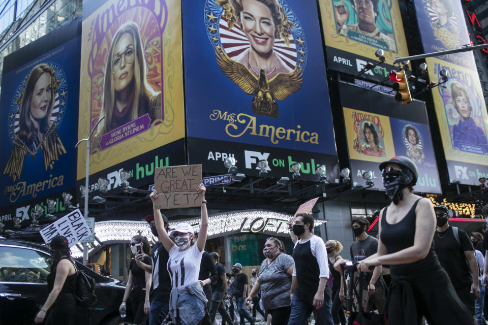 Protesters march through Times Square during a solidarity rally calling for justice over the death of George Floyd, Wednesday, June 3, 2020, in New York. Floyd died after being restrained by Minneapolis police officers on May 25. (AP Photo/Wong Maye-E)