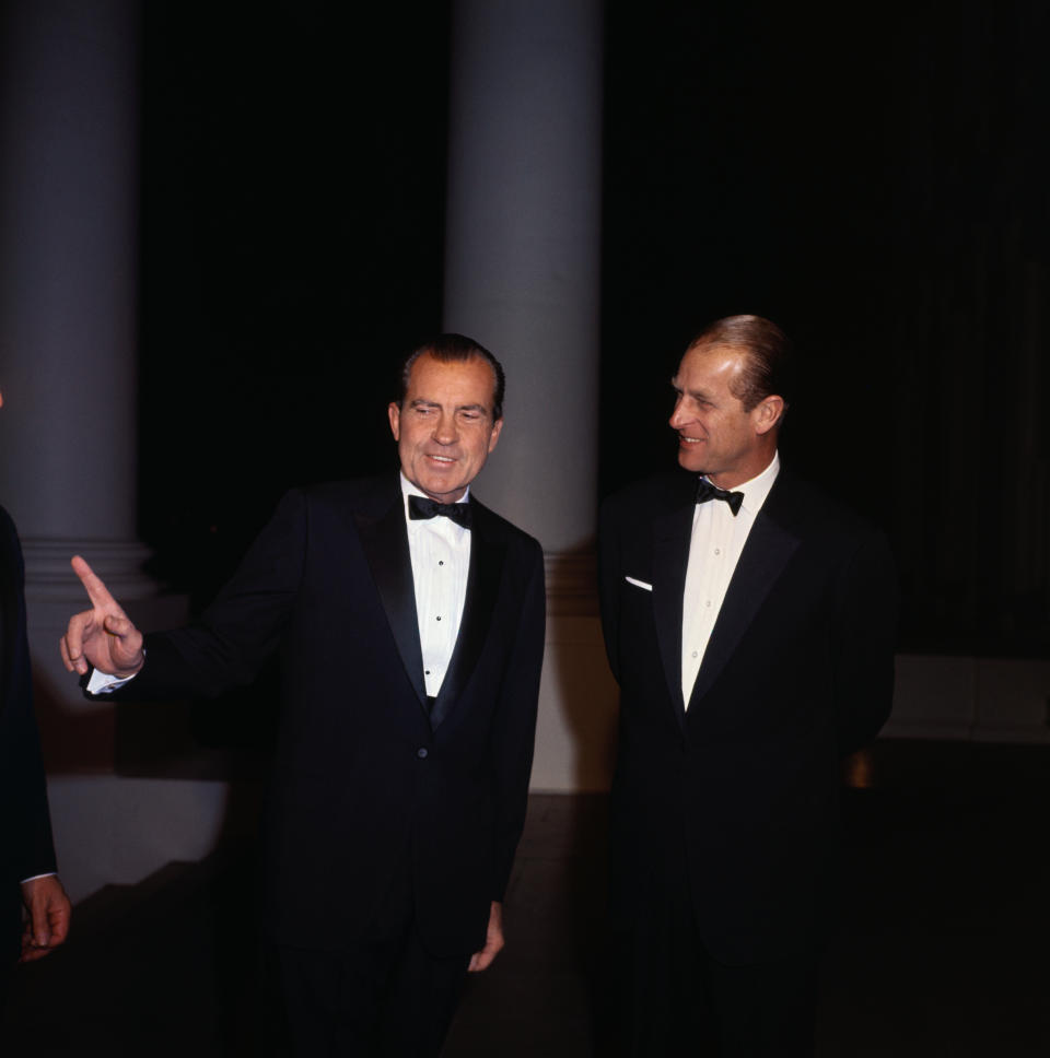 (Original Caption) Washington, D.C.: Prince Philip of Great Britain (left) talks with President Nixon during White House visit. At right (mostly hidden) is Secretary of State William P. Rogers.