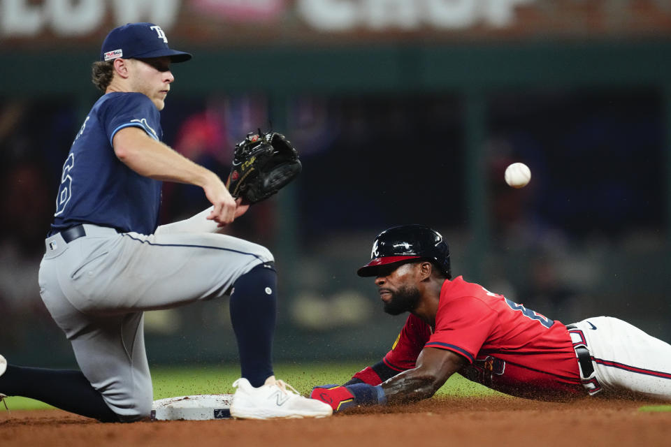 Atlanta Braves' J.P. Martínez steals second base as Tampa Bay Rays shortstop Taylor Walls (6) handles the late throw in the eighth inning of a baseball game Friday, June 14, 2024, in Atlanta. (AP Photo/John Bazemore)