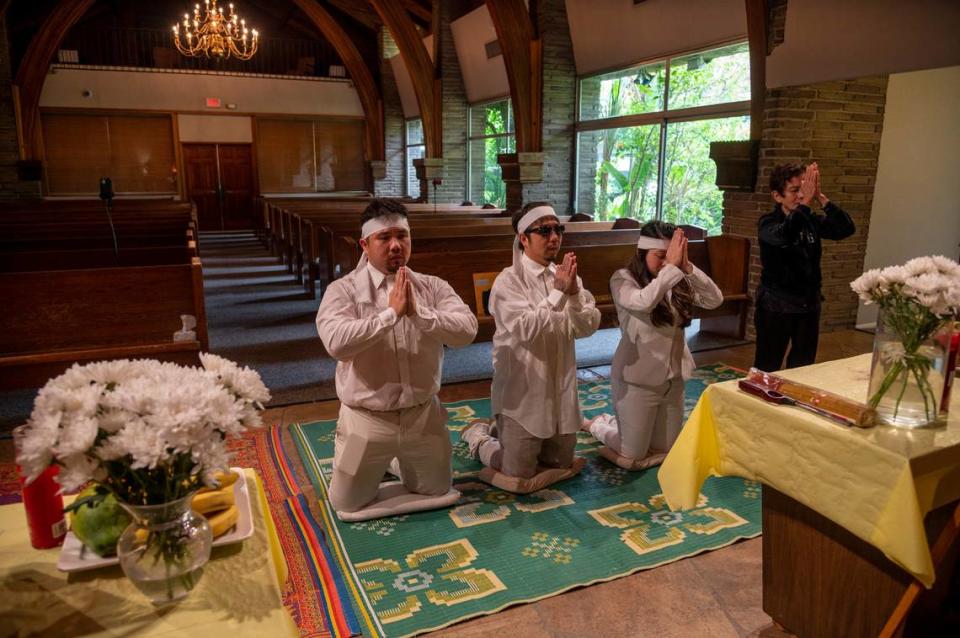 At Dung Tan Nguyen’s funeral, family members, from left, Michael Chambon, Bao Nguyen, Trang Nguyen and Kim Anh Dinh, chant a Buddhist prayer, on Wednesday, May 6, 2020, during a service that would have been full of family and community members if it wasn’t for the safety precautions put in place to protect against the coronavirus.