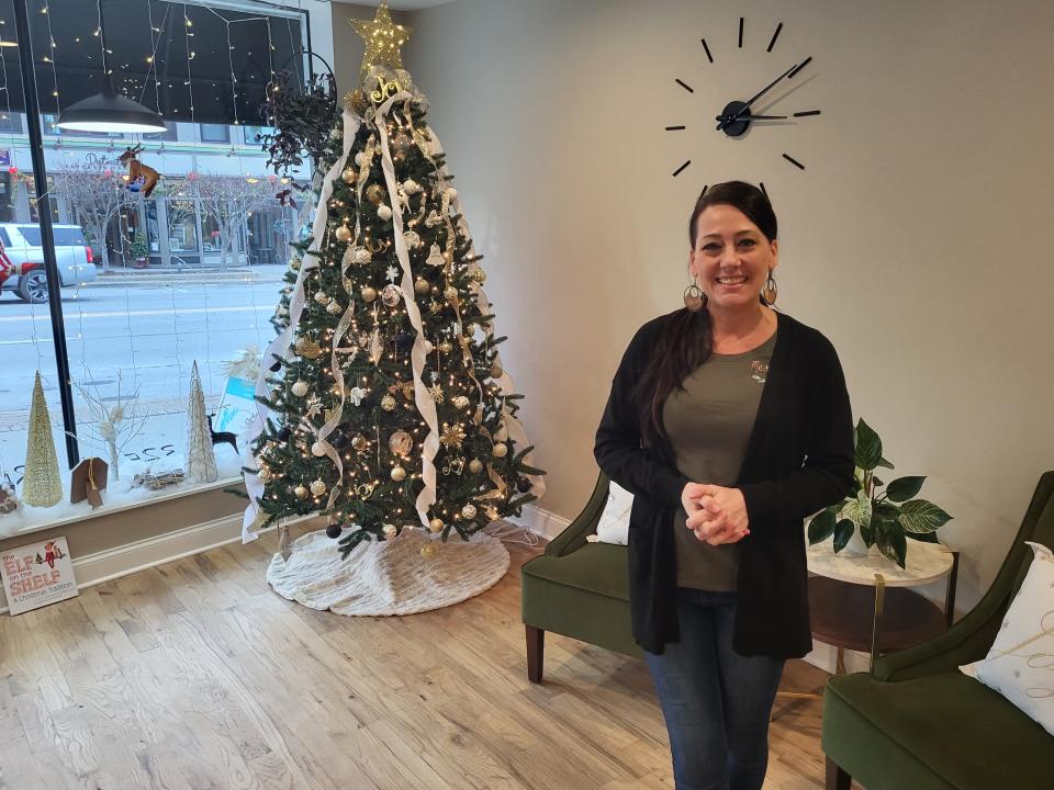 Massage 325 owner Michelle Sheffer stands toward the front of her storefront space, decorated for Christmas, in downtown Port Huron on Monday, Dec. 19, 2022.