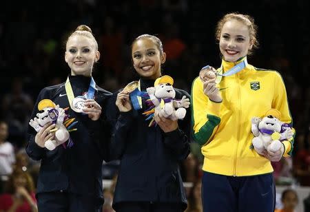 Jul 20, 2015; Toronto, Ontario, CAN; Jasmine Kerber of the United States (left) , Laura Zeng of the United States (middle) and Angelica Kvieczynski of Brazil (right) on the podium after the rhythmic gymnastics ribbons final during the 2015 Pan Am Games at Toronto Coliseum. Mandatory Credit: Rob Schumacher-USA TODAY Sports