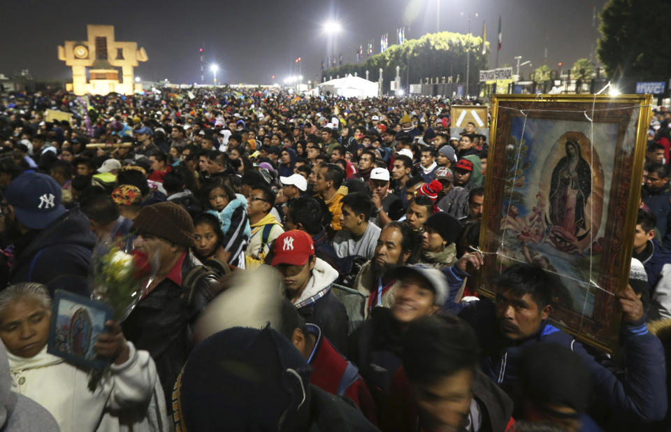 FILE - In this Dec. 12, 2019 file photo, pilgrims arrive at the plaza outside the Basilica of Our Lady of Guadalupe in Mexico City. Due to the COVID-19 pandemic, the Mexican Catholic Church announced on Monday, Nov. 23, 2020 the cancelation of the annual pilgrimage, the largest Catholic pilgrimage worldwide. (AP Photo/Marco Ugarte, File)