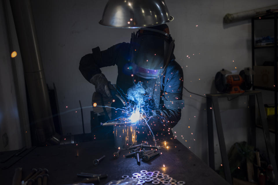 A Ukrainian welder builds a tyre deflation stringer spike system in Lviv, western Ukraine, Saturday, March 12, 2022, in Lviv. Russia's war on Ukraine is now in its third week, the war has expanded to areas in western Ukraine, closer to NATO members Poland and Romania. The war has forced more than 2.5 million people to flee Ukraine. (AP Photo/Bernat Armangue)