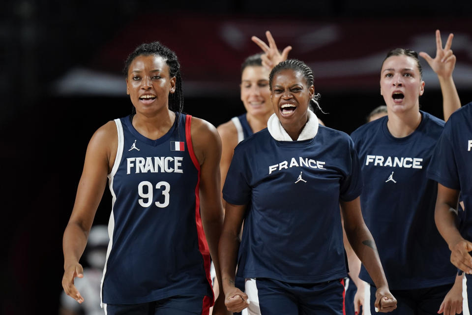 France's Diandra Tchatchouang (93) celebrates with teammates on the bench during a women's basketball quarterfinal round game against Spain at the 2020 Summer Olympics, Wednesday, Aug. 4, 2021, in Saitama, Japan. (AP Photo/Eric Gay)