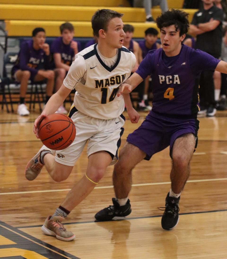 Erie Mason’s Jackson Iocoangeli is guarded on the baseline by Evan Southerfield of Plymouth Christian Tuesday night. Plymouth Christian won 88-53.