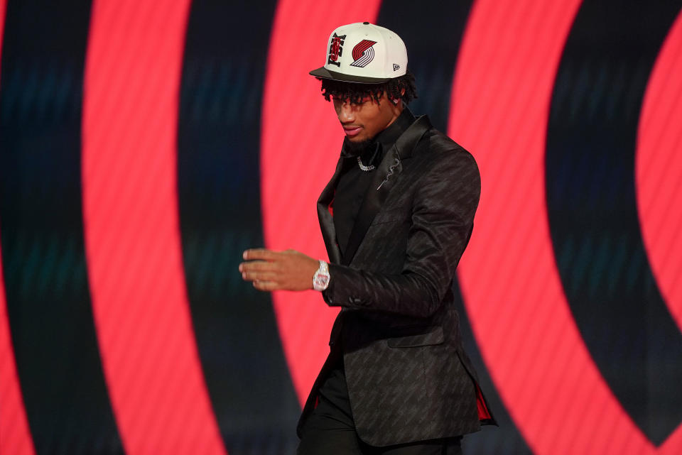 Shaedon Sharpe walks across the stage after being selected seventh overall by the Portland Trailblazers in the NBA basketball draft, Thursday, June 23, 2022, in New York. (AP Photo/John Minchillo)