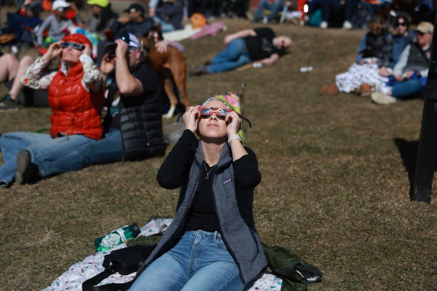 HOULTON, MAINE – APRIL 08: People watch the eclipse on April 08, 2024 in Houlton, Maine. Millions of people have flocked to areas across North America that are in the “path of totality” in order to experience a total solar eclipse. During the event, the moon will pass in between the sun and the Earth, appearing to block the sun. (Photo by Joe Raedle/Getty Images)