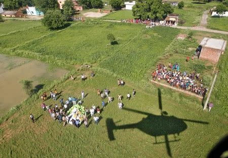 An Indian Air Force helicopter casts a shadow after supplying relief goods to the flood victims on the outskirts of Allahabad, India, August 24, 2016. REUTERS/Jitendra Prakash