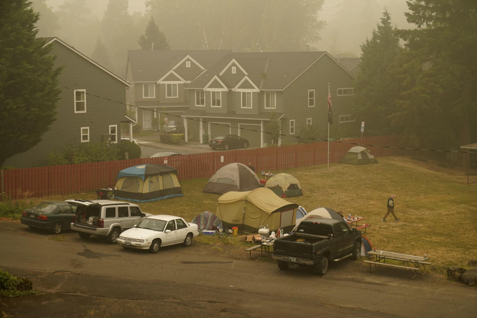 Evacuees from the Riverside Fire stay in tents at the Milwaukie-Portland Elks Lodge, Sunday, Sept. 13, 2020, in Oak Grove, Ore. (AP Photo/John Locher)