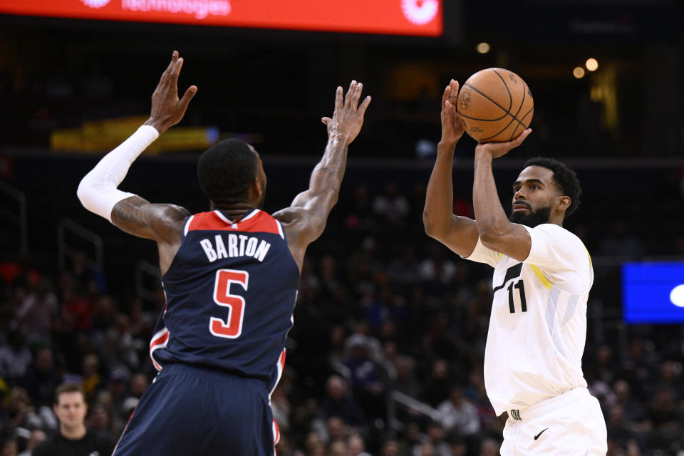 Utah Jazz guard Mike Conley (11) shoots against Washington Wizards forward Will Barton (5) during the first half of an NBA basketball game Saturday, Nov. 12, 2022, in Washington. (AP Photo/Nick Wass)