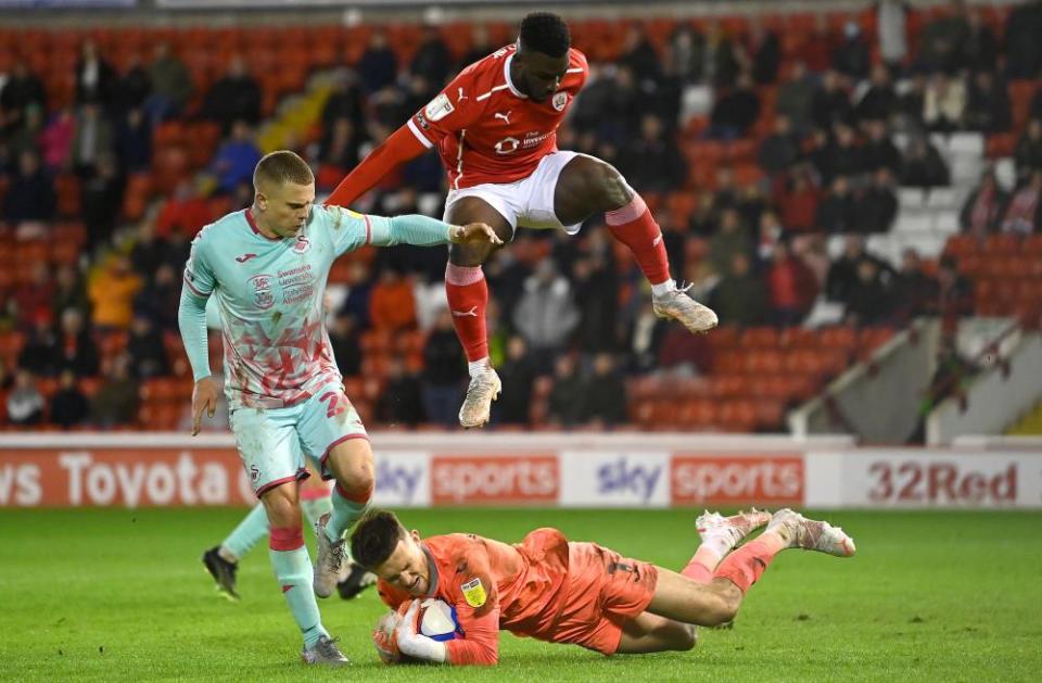 Freddie Woodman (bottom) made a series of important saves for Swansea.