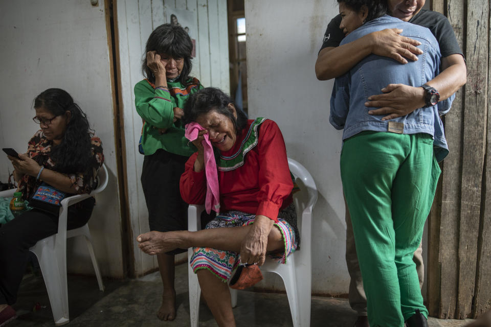 Relatives mourn the death of Jessica Soria Gonzáles, a 50-year-old Shipibo Amazonian indigenous artist who died due to complications related to COVID-19, at a burial ceremony in Pucallpa, in Peru's Ucayali region, Wednesday, Oct. 7, 2020. (AP Photo/Rodrigo Abd)