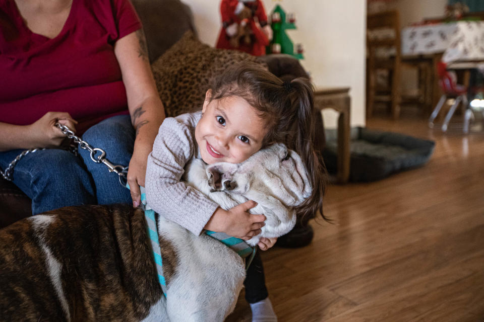 Annaya Garcia hugs Bruno at the home of her grandmother, Iris Salaiz in Las Cruces on Thursday, Dec. 2, 2021. Bruno was returned to Salaiz this week after he had gone missing for three years.