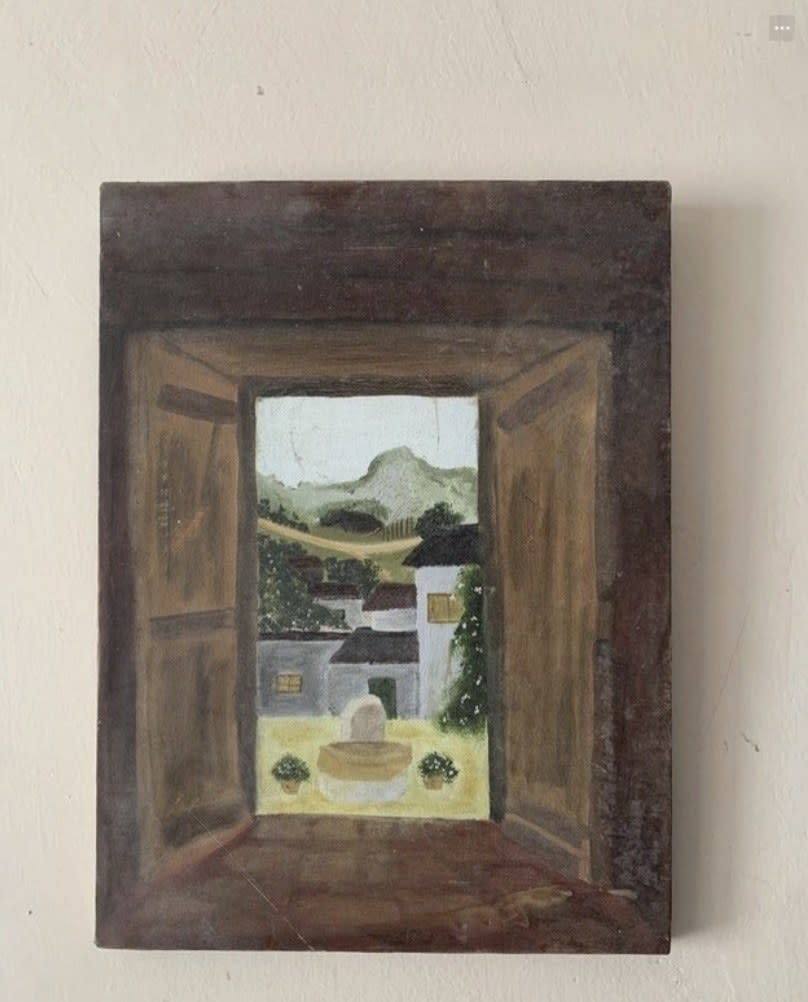 A framed painting on a wall.