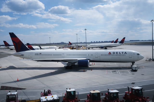 <p>Spencer Platt/Getty</p> Delta plane at John F. Kennedy Airport in New York City